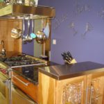 A kitchen with a stove and cabinets in it
