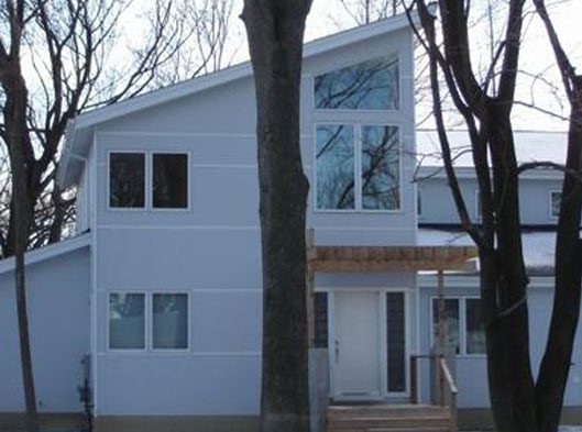 A white house with trees in the background