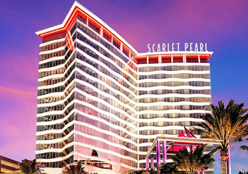Modern hotel building at twilight with illuminated signage - scarlet pearl casino resort.